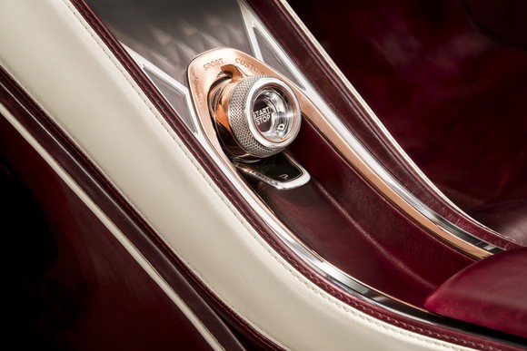 A close-up of the glass "Start" button in the Bentley EXP 12 Speed 6e Concept.