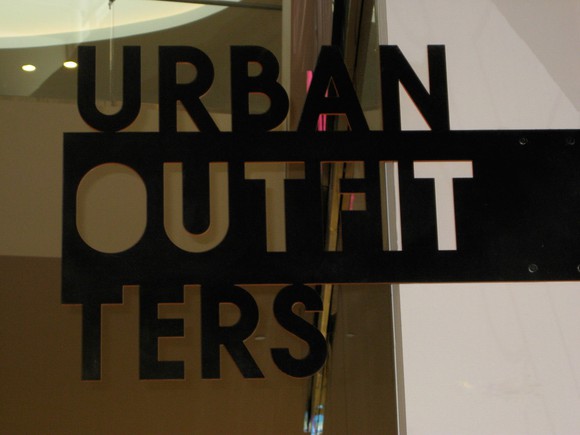 A sign on the window of an Urban Outfitters store
