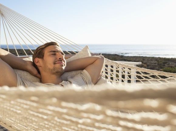 Man sleeping in hammock.