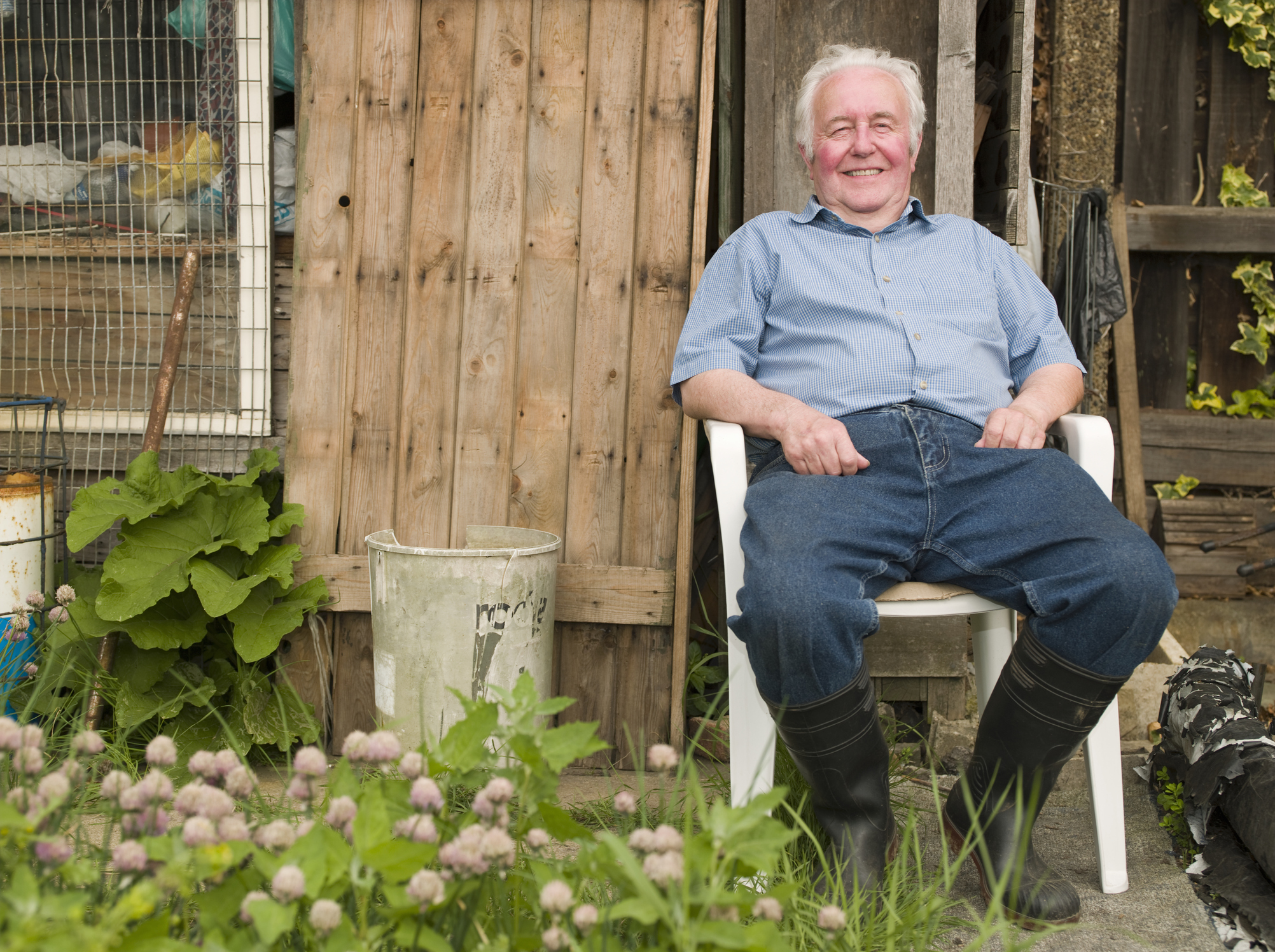 Senior man sitting in a garden