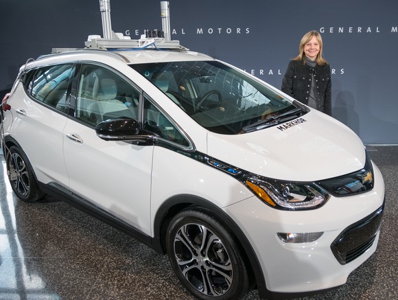 A white Chevy Bolt in a showroom.