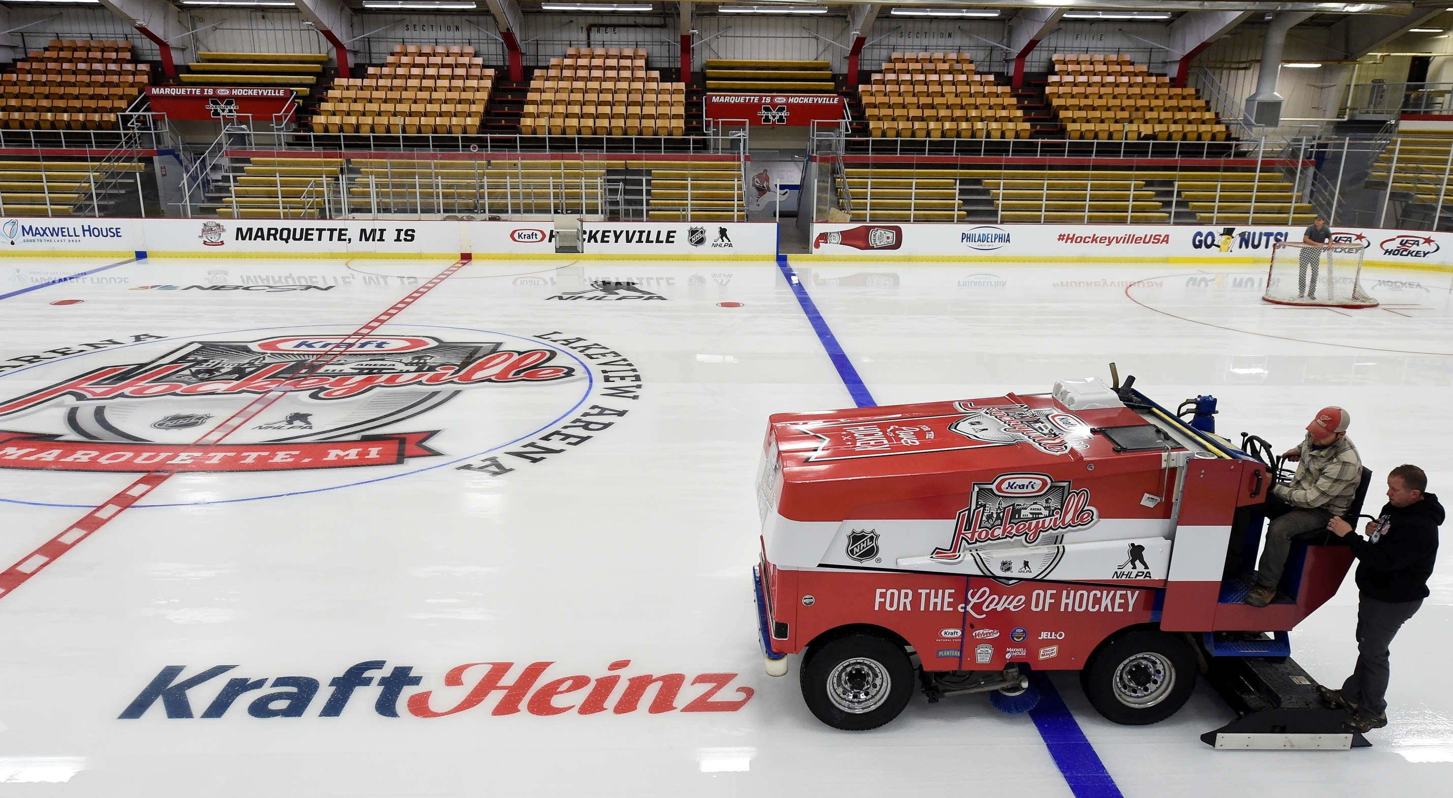 Zamboni on hockey rink with Kraft Heinz logo on it.
