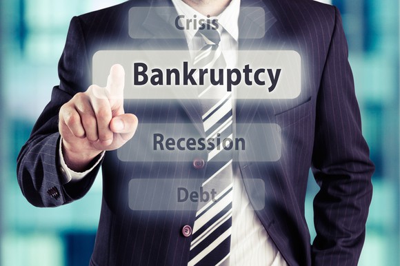 Businessman pointing toward bankruptcy.