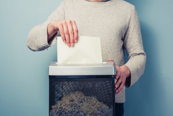 Man shredding documents in a paper shredder