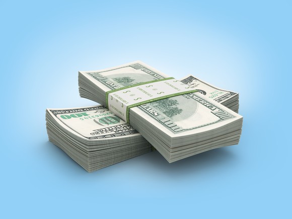 Two criss-crossed stacks of hundred-dollar bills.