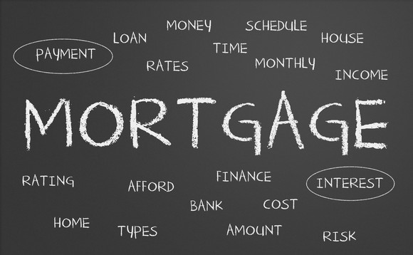 The word "mortgage" written on a blackboard surrounded by smaller related words such as interest and payment