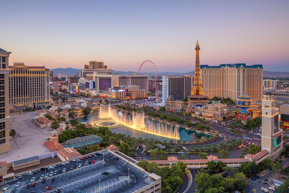 The Las Vegas Strip at sunset, with the Bellagio fountains mid-performance.