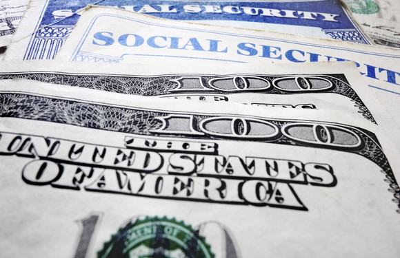Social Security card with hundred dollar bills