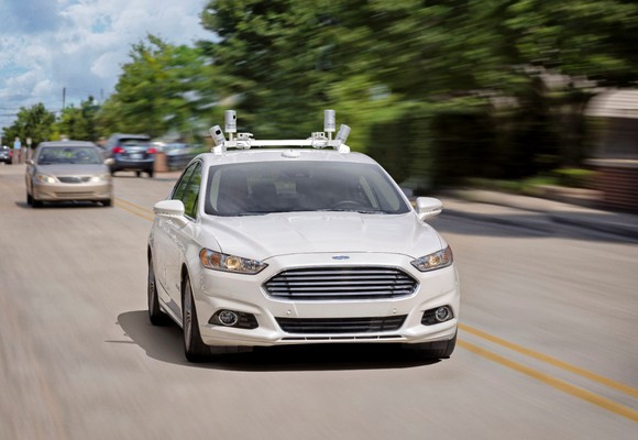 A self-driving Ford Fusion being tested on a road.