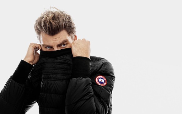 A male model poses in a Canada Goose jacket