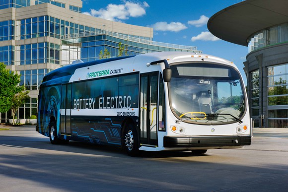 A Proterra electric bus drives down the road.