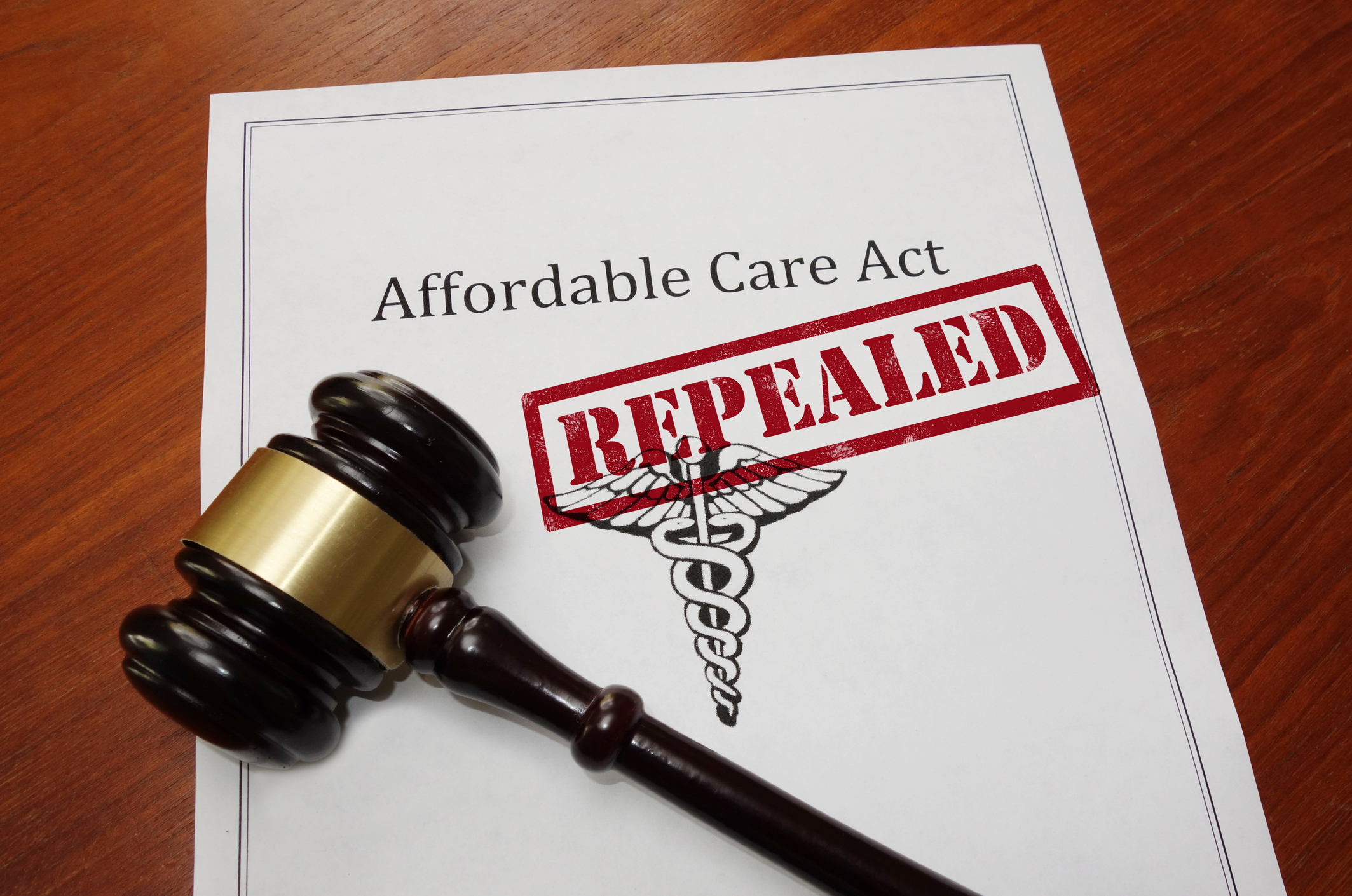 Mock Copy of Affordable Care Act bill with repealed stamp, and a gavel sitting on top.