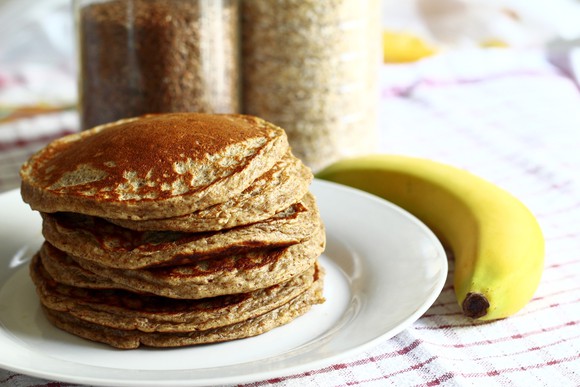 A stack of pancakes and a banana.