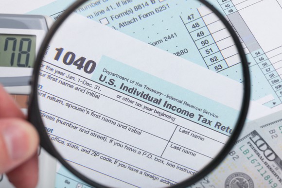 A magnifying glass highlighting IRS Form 1040.