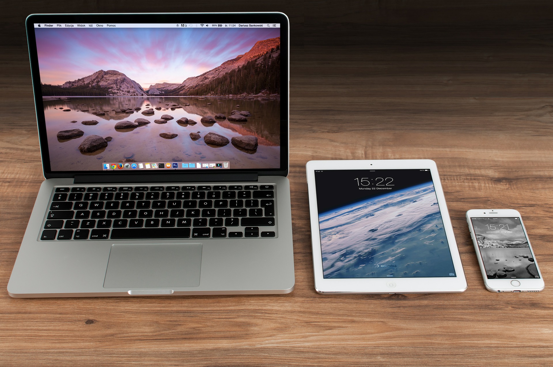 Apple MacBook, iPad, and iPhone on a table.