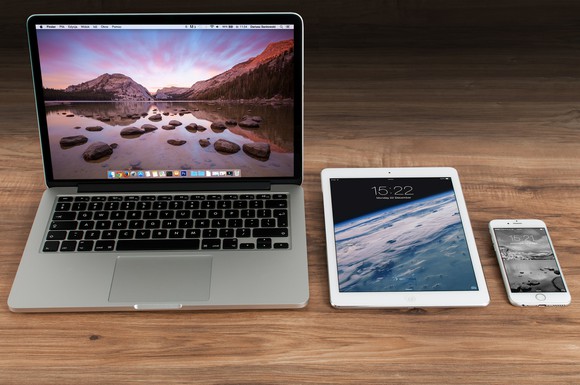 Apple MacBook, iPad, and iPhone on a table.