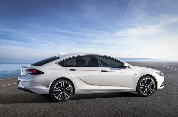 A white 2018 Opel Insignia Grand Sport in a parking lot on a sunny day.