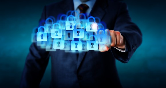 A businessman touches a cloud of virtual padlocks.