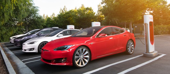 Tesla vehicles at a Supercharger