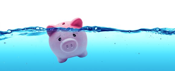 A piggy bank struggles to stay above water.