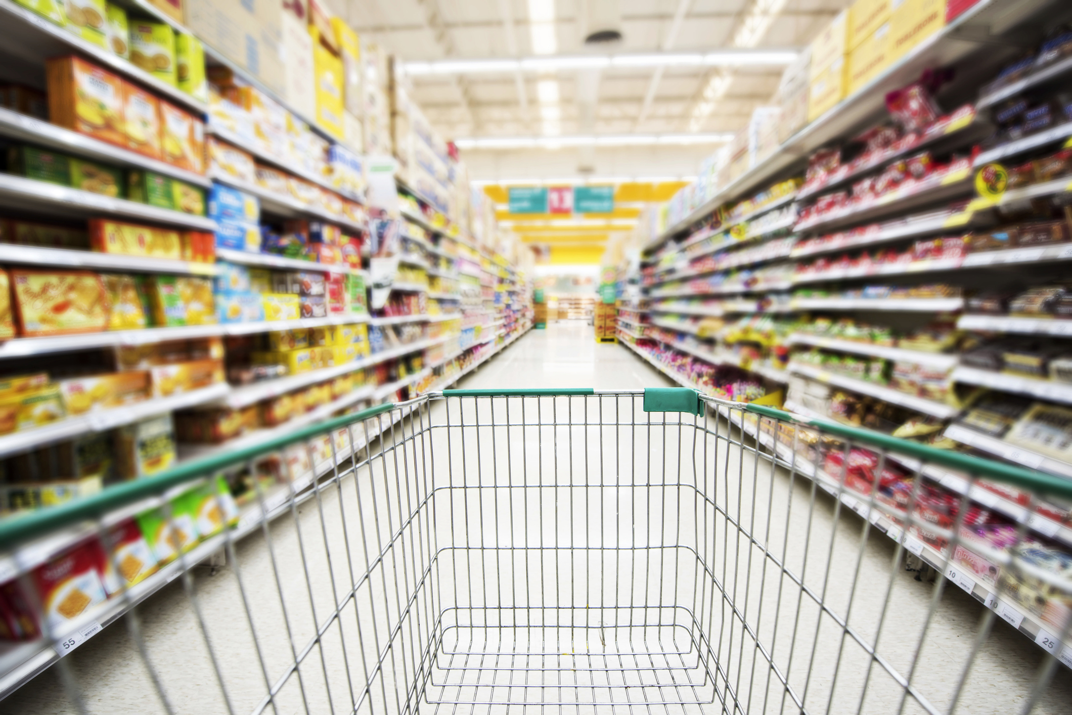 A shopping cart in a store aisle.