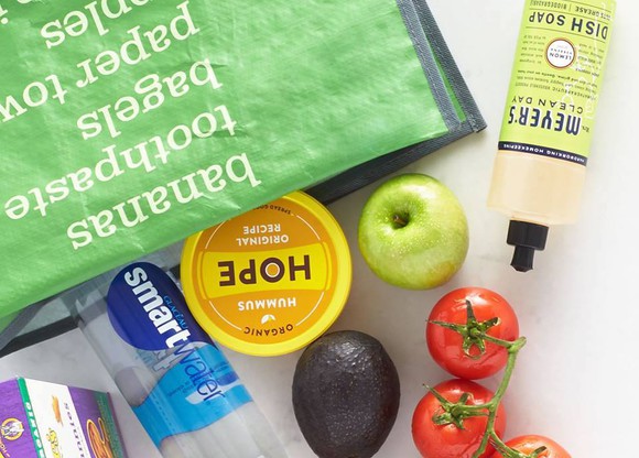 Picture of Amazon Fresh grocery bag with food coming out of it.