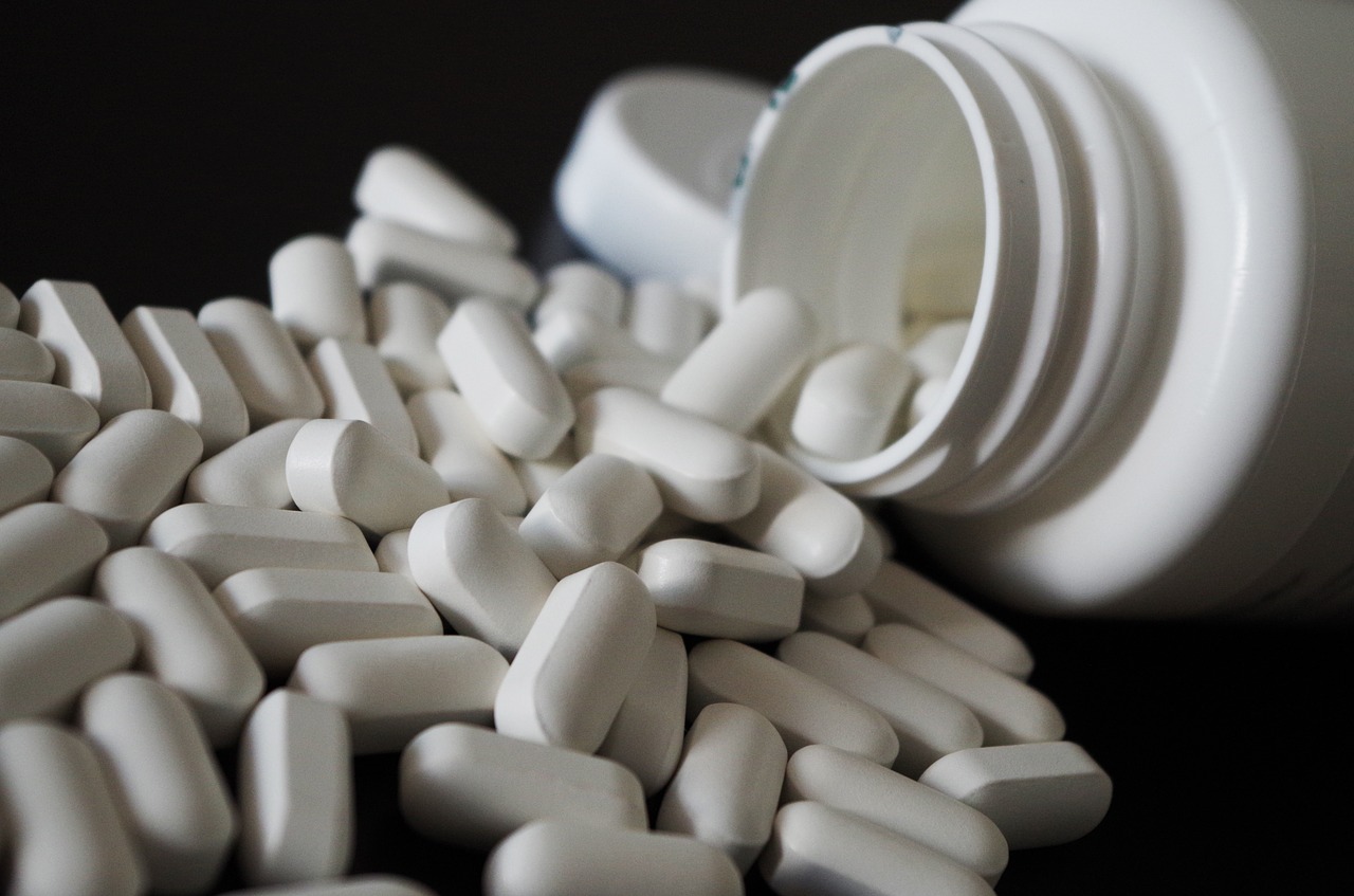 Pills spilling out of a bottle.