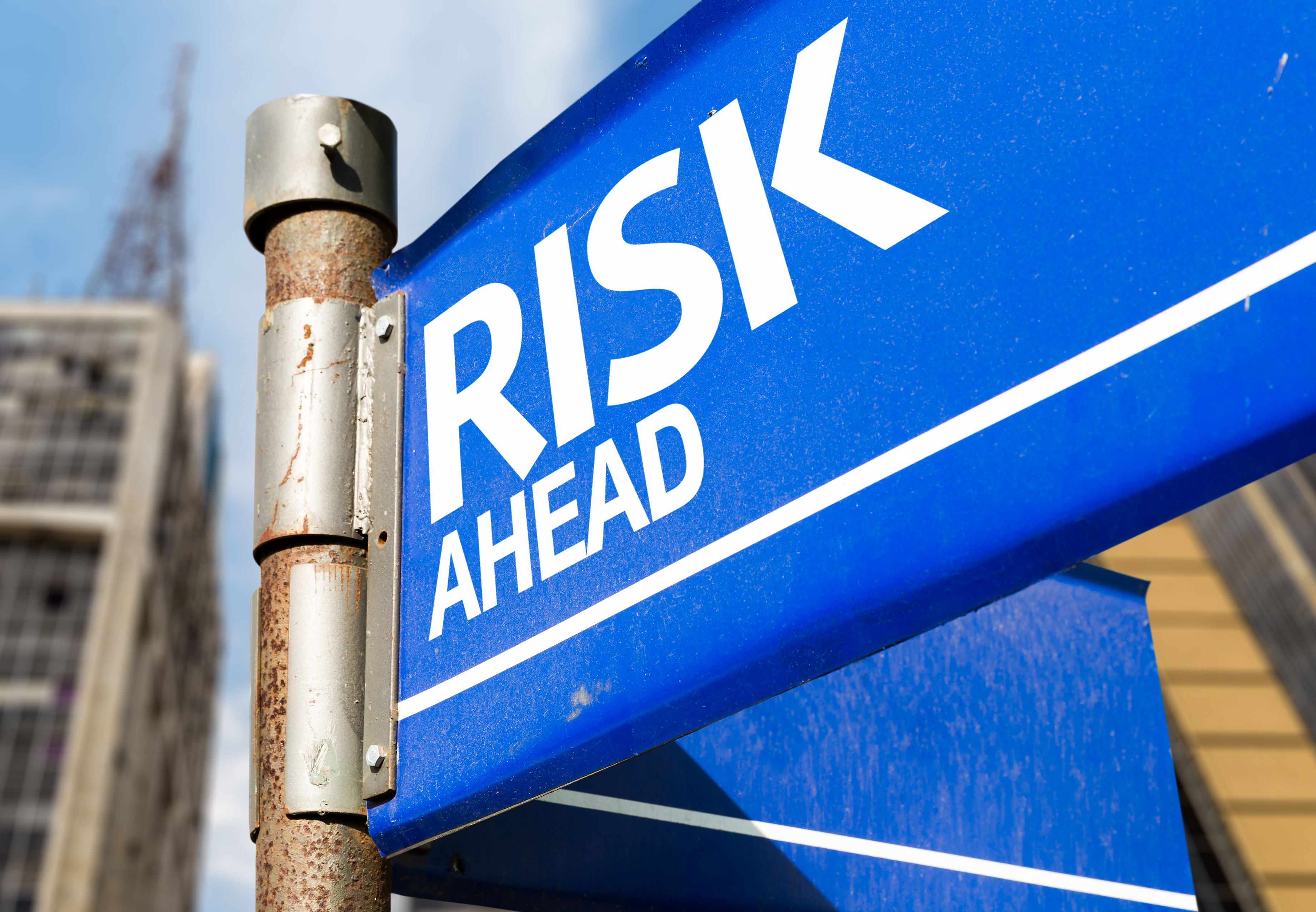A street sign implying risk ahead with high-yield dividend stocks.