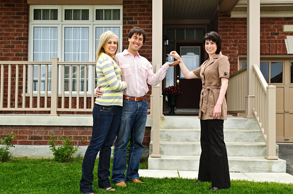 Couple and realtor at a mortgage closing