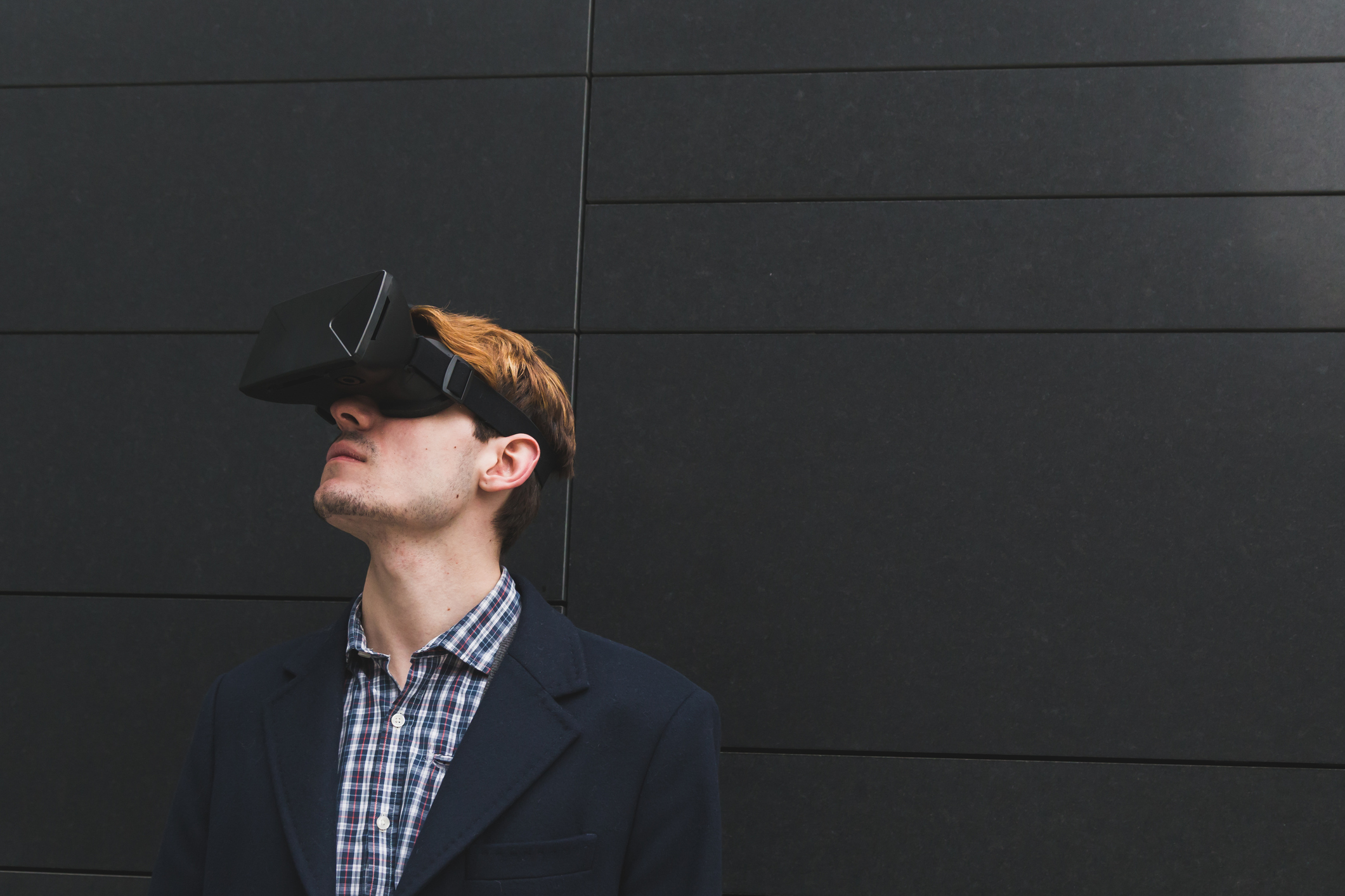 Young man wearing a virtual reality headset.