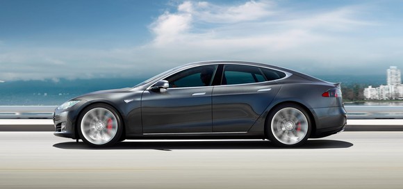 A Tesla Model S driving on a sunny day.