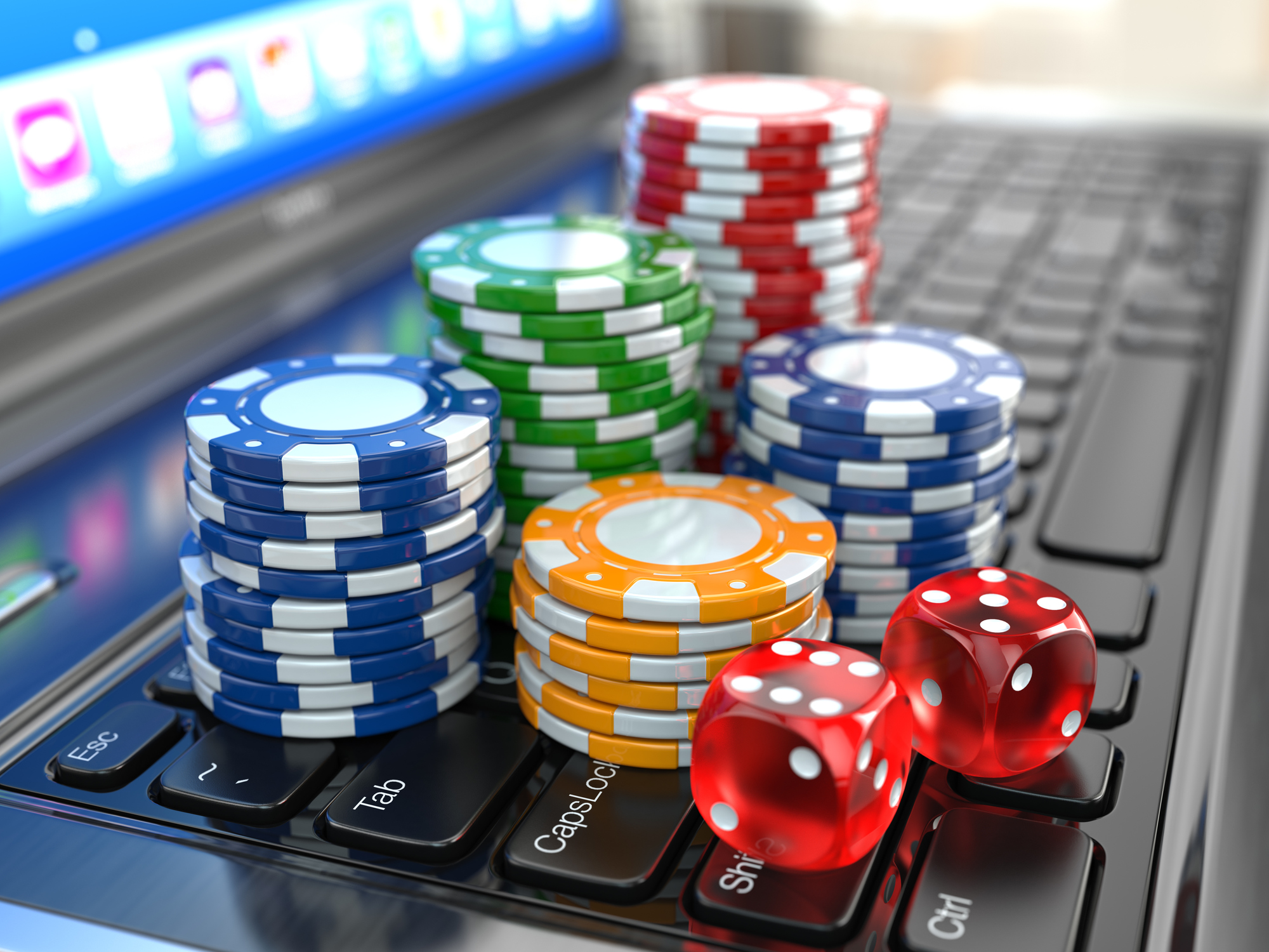 Casino chips piled on a laptop computer