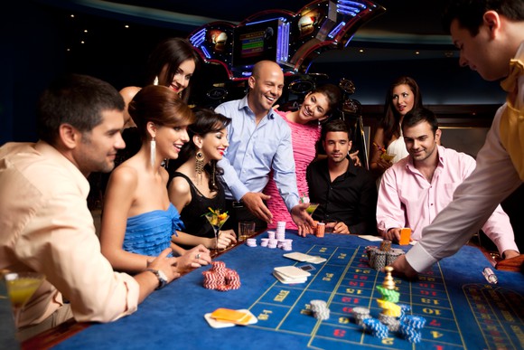People around a gaming table in a casino.