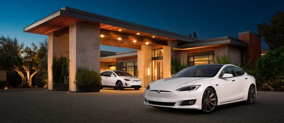 Model S and Model X parked outside a house