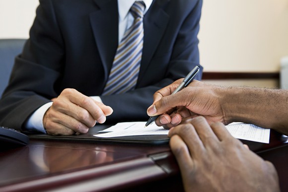 A man signs some papers