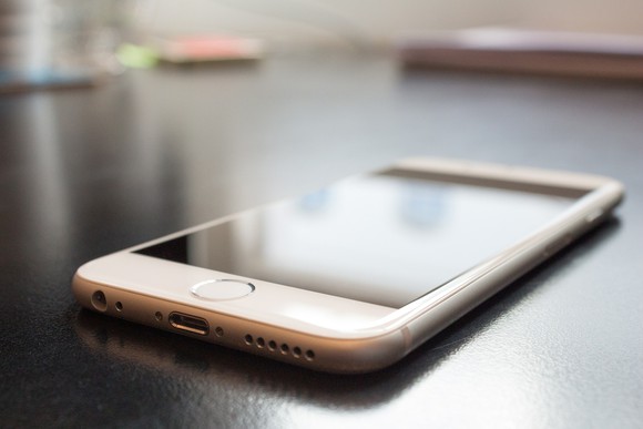 An iPhone is sitting on a table