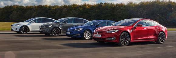 Four Tesla vehicles driving