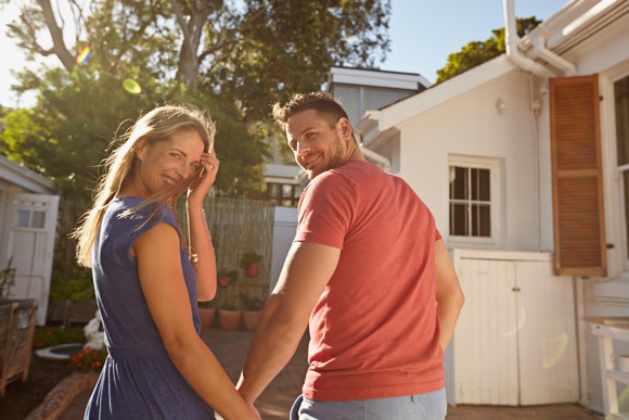 Young couple outside their home