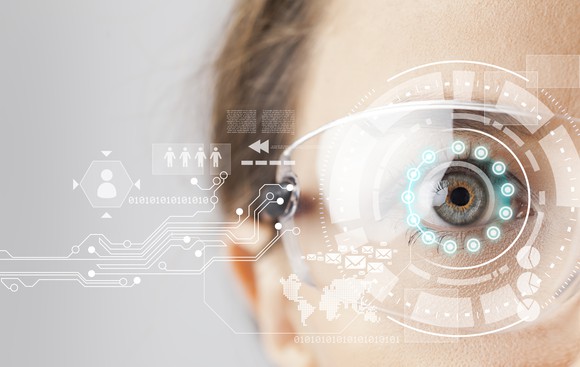 An augmented reality display being projected onto a woman's eye.