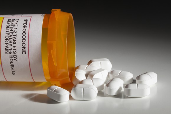 Hydrocodone bottle and pills