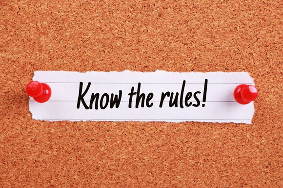 "Know The Rules!" written on note paper pinned on a corkboard.