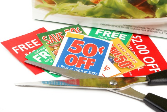 a bunch of coupons with a pair of scissors next to them