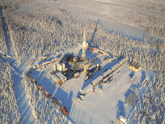 A drilling rig in the snowy Canadian landscape.