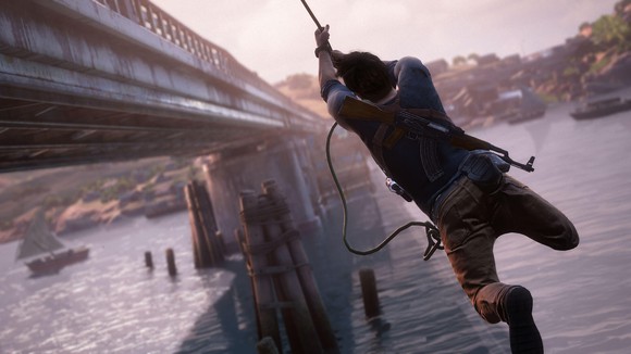 Nathan Drake from Sony's "Uncharted" series swinging from a rope alongside a bridge.
