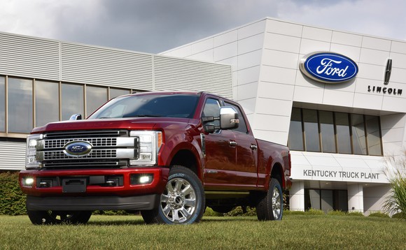 A red Ford Super Duty pickup in front of Ford's Kansas City Assembly plant