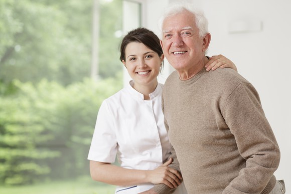 Assisted living worker with elderly man