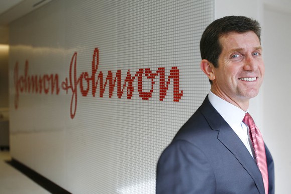 Johnson & Johnson CEO Alex Gorsky standing in from of the Johnson & Johnson logo.