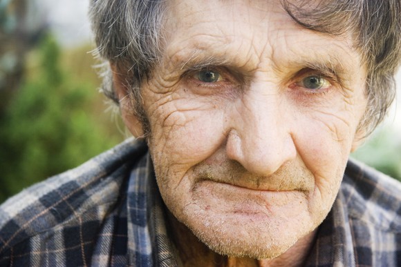 An old man pondering whether he'll receive enough Social Security income to meet his expenses.