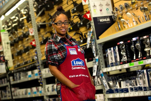Female employee in Lowe's bathroom fixtures aisle
