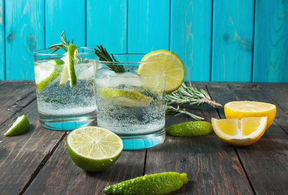 Refreshing glass of carbonated water with lemons and lime